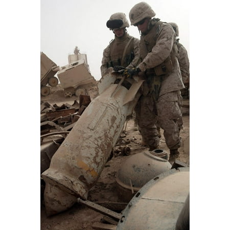 Marines lift up a bomb to determine if it still poses a threat Poster Print by Stocktrek Images