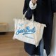 thumbnail image 2 of Bolso de mujer de gran capacidad, superventas 2024, bolso de hombro de lona de color sólido a la moda, bolso de mano de alta calidad con borlas y letras, 2 of 5