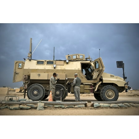 October 26 2011 - US Army Sergeant refuels his mine-resistant ambush protected Caiman vehicle at Joint Base Balad Iraq Poster