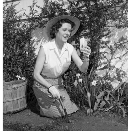 Mid adult woman gardening and drinking lemonade Canvas Art -  (18 x