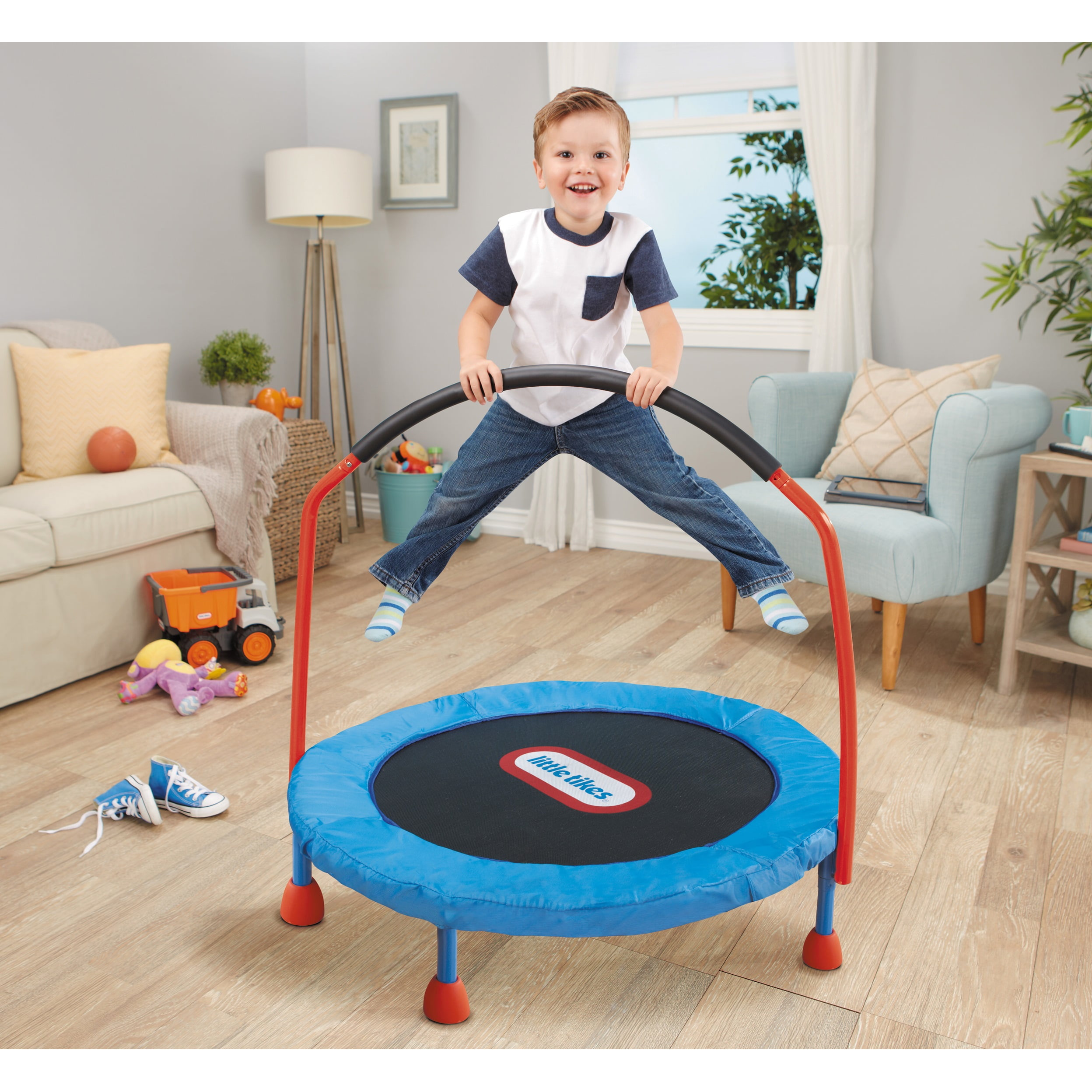 A toddler jumping on a Little Tikes Toddler Trampoline