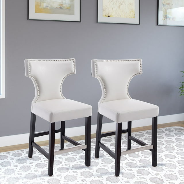 Set of two CorLiving Kings white studded faux leather counter height indoor barstools with dark wood legs on patterned rug.