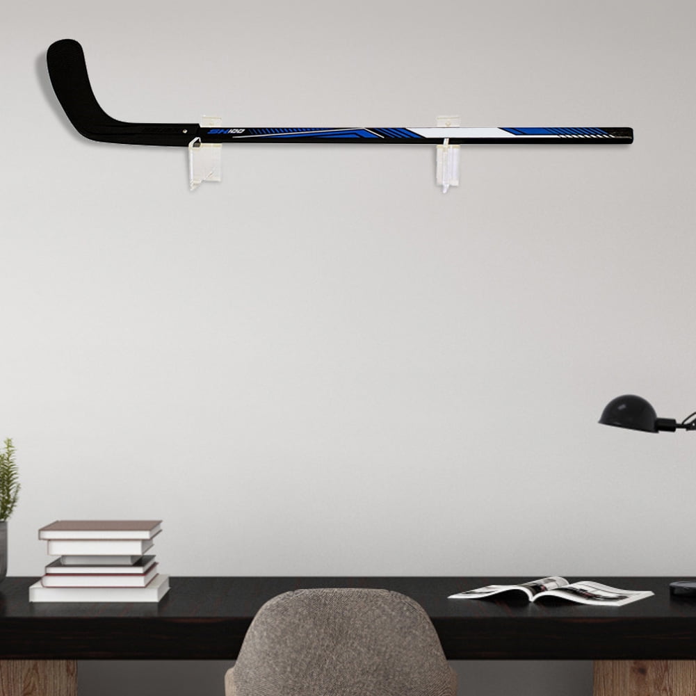 hanging hockey sticks on wall