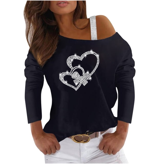 camisas informales de manga larga para mujer, jersey con hombros descubiertos, blusa holgada con lentejuelas brillantes, tops tipo túnica Blusa túnica negra, vista frontal 3/4; silueta suelta de manga larga con hombro descubierto y tirante decorativo brillante en un lado; detalle central de corazones formados por lentejuelas plateadas; modelo con pantalón claro y cinturón, adecuada para uso diario o fiesta; a menudo usada también como top casual para salidas informales.