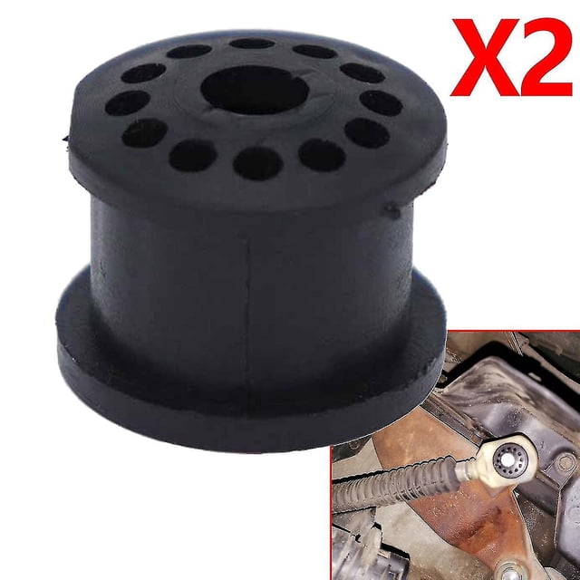 kit de reparación de buje de goma para palanca de cambios de transmisión manual ford fiesta mk5 2002-2008, pieza de repuesto: vista frontal centrada de un buje de goma negro cilíndrico con orificio central y varios orificios periféricos, labio inferior plano; marcado X2 en rojo en la esquina superior y recorte que muestra el buje instalado en el soporte del cable de cambio. Adecuado para reparar el buje de conexión del cable de cambio en Ford Fiesta 2002–2008.