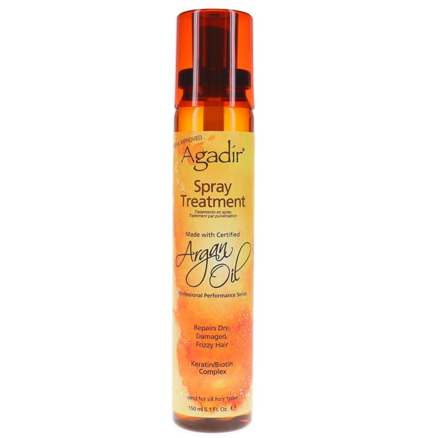 tratamiento de aerosol de aceite de agadir argan 5.1 oz botella alta frontal con tapa naranja translúcida; envase cilíndrico con etiqueta amarilla y logo Agadir que indica "Spray Treatment" y "Argan Oil", formulado para reparar cabello seco, dañado y con frizz; spray ligero para usar sobre cabello húmedo antes del enjuague o sobre cabello seco para brillo y protección al peinar.