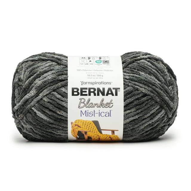 Bernat® Blanket Mist-ical™ #6 Super Bulky Polyester Yarn in dark and light grey with watercolor marbling effect, 10.5oz/300g, 220 yards, shown front-facing with label featuring a yellow knitted blanket on a wooden chair, ideal for knitting and crochet, machine washable and dryable.