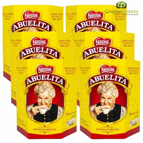 Nestle Chocolate Abuelita - Mexican Hot Chocolate Tablets 540g/1.19lbs 6 PK. A front-facing view of six yellow boxes featuring the iconic Abuelita branding, showcasing authentic Mexican hot chocolate drink tablets. Each box contains 540g of cocoa, sugar, and cinnamon-infused tablets, ideal for creating rich, creamy beverages or as a base for desserts. Suitable for bulk drink mixes and versatile culinary use.