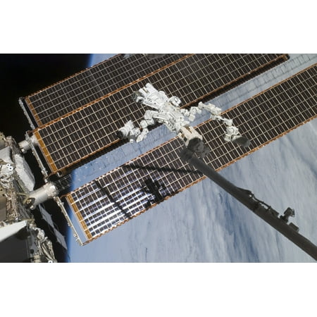 The Canadian-built Dextre robotic system in the grasp of the robotic Canadarm2 Poster Print