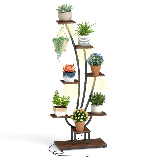 Gymax 62'' Tall 8-Tier Corner Metal Plant Shelf for Multiple Plants Living Room Balcony. This plant stand features a curved metal frame with 8 tiers, including 1 large shelf, 7 smaller shelves, and a hanging hook, ideal for displaying potted plants. Equipped with 4-head grow lights offering 10 brightness levels and 3 timer settings, it promotes healthy indoor plant growth. The sturdy metal construction includes adjustable footpads and anti-toppling devices for stability. The shelves are made of engineered wood in a brown finish, and the stand measures 26.5'' x 12'' x 62'' (L x W x H).
