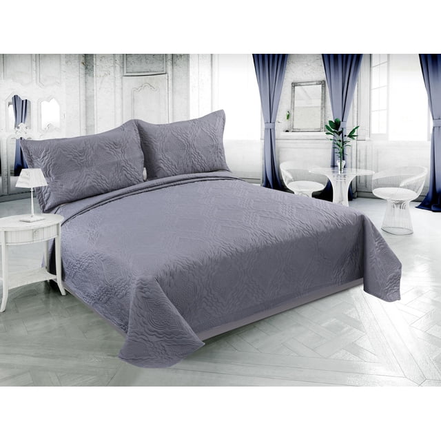 Grey Marina Decoration solid embossed pinsonic coverlet bedspread and matching shams displayed on a modern bed in a bright, stylish bedroom.