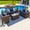 Sunbrella Canvas Navy, variant on Tuscany 4 Piece XL Resin Wicker Outdoor Patio Conversation Sofa Set in Brown w/ Three-seat Sofa, Loveseat, Armchair, and Coffee Table (Half-Round Brown Wicker, Polyester Light Gray)