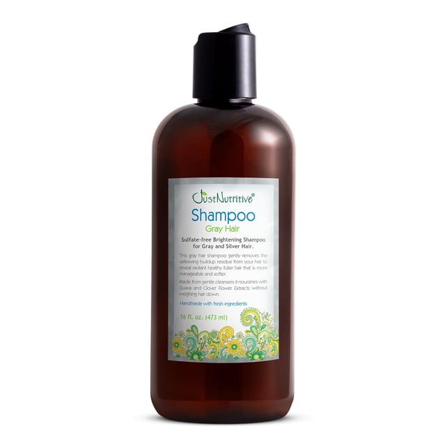 tratamiento para cabello gris shampoo just nutritive 473ml botella frontal ámbar con dispensador negro; etiqueta blanca con texto azul y verde que indica 'Shampoo Gray Hair', gráfico floral verde en la base y leyenda que menciona que neutraliza tonos cobrizos, envase de 473 ml.