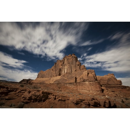 This redrock formation illuminated by a full moon is near the popular Park Avenue hiking trail in Arches National Park Utah Poster