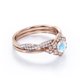 thumbnail image 3 of JeenMata Anillo de Bodas con Banda Retorcida Infinita de Piedra Lunar Azul y Moissanita de Corte Redondo de 1,75 Quilates con Bisel de Halo de Flores Engastado en Oro Rosa de 18 K sobre Plata, 3 of 6