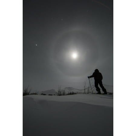 Man snowshoeing along the Dempster Highway under a moon glowing with rings Yukon Canada Canvas Art - Robert Postma Design Pics (24 x 38)