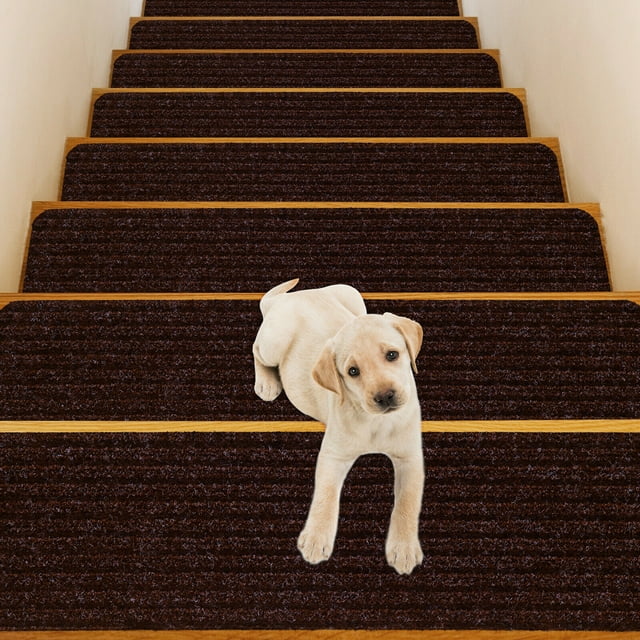 Gymax 15 PCS Slip-resistant Stair Mats 30'' x 8'' Non-Slip Stair Treads Carpet in brown, shown installed on wooden stairs. The mats are made of durable polyester fabric with a non-slip PVC bottom, designed to reduce noise and provide safety for children, the elderly, and pets. A small dog is sitting on one of the stair mats, highlighting its suitability for pet-friendly homes. The mats are easy to install, washable, and can be cut to fit various stair sizes.
