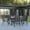Black, variant on Emma + Oliver Seven Piece Patio Table Set with 31.5" x 55" Metal Table with Tempered Glass Top and 6 Red Flex Comfort Stacking Chairs