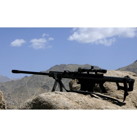 A Barrett 50-caliber M107 Sniper Rifle sits atop an observation point in Afghanistan Rolled Canvas Art - Stocktrek Images (8 x