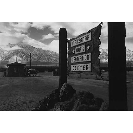 Wooden sign at entrance to the Manzanar War Relocation Center with a car at the gatehouse in the background  Ansel Easton Adams was an American photographer best known for his black-and-white