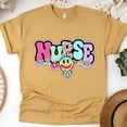 thumbnail image 1 of T-Shirt Graphique pour Infirmière avec Lettres Pastel Rétro et Design Souriant, Or, Taille 2TG, 1 of 6
