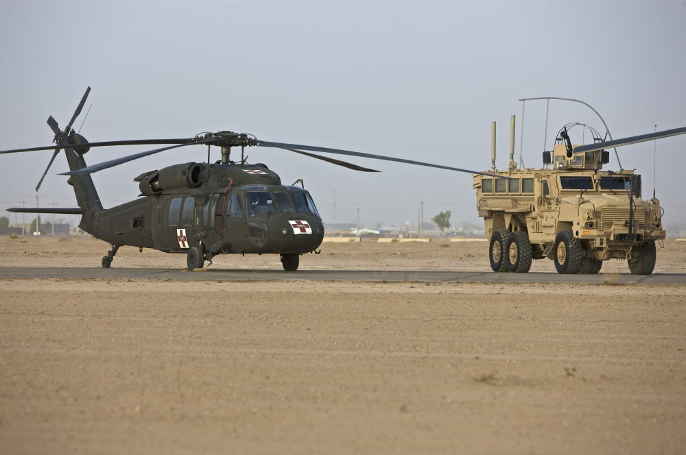 A U.S. Army medevac UH-60 Black Hawk helicopter and a RG-33 MRAP ...