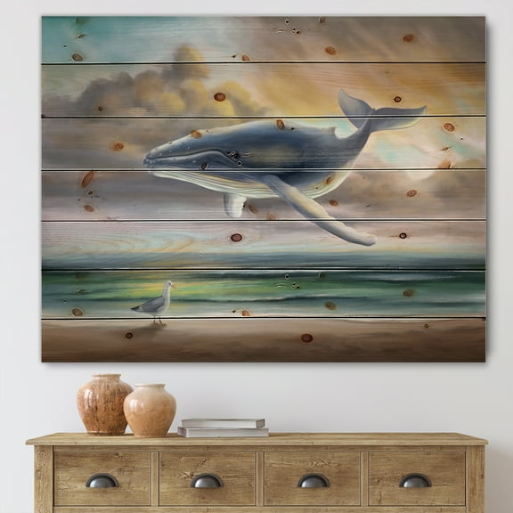 Designart 'Whale Floating In The Sky Over Beach' Children's Art Print on Natural Pine Wood
