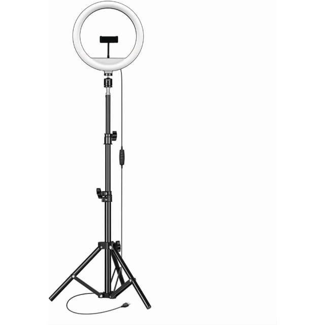 lámpara aro de luz led 10'' regulable con trípode y modos de iluminación para fotografía y video Aro de luz LED de 10 pulgadas sobre trípode ajustable, vista frontal; anillo circular blanco con soporte central para celular, cable de alimentación con control de brillo en línea y patas desplegadas sobre fondo blanco. Adecuada para fotografía, video, maquillaje y como luz de relleno para transmisiones en vivo.