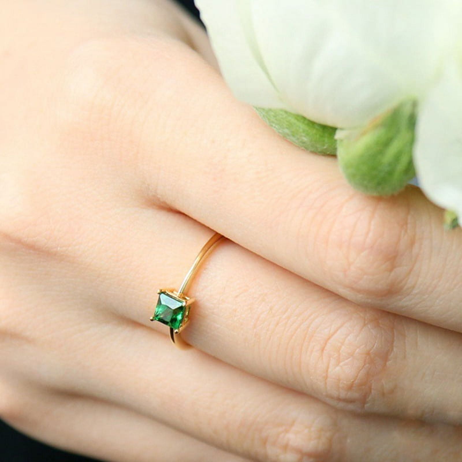 Two layered platinum cz ring with emerald green stone -