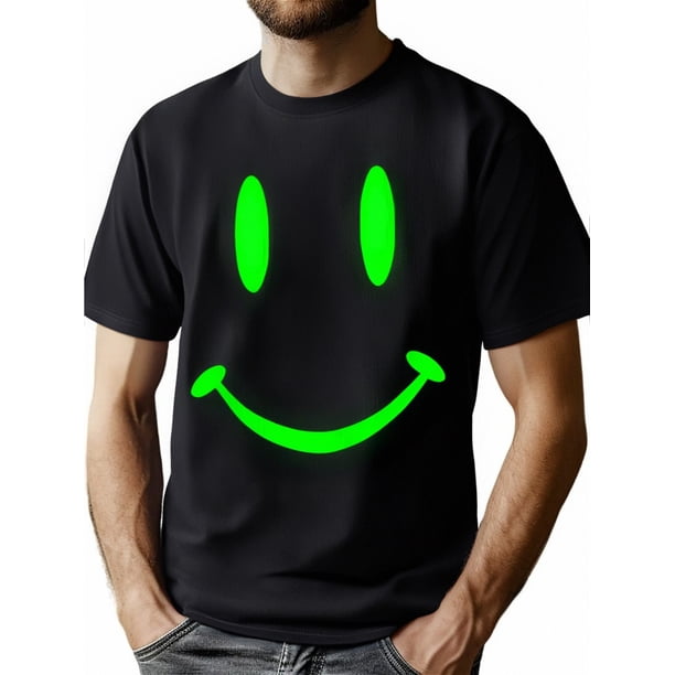 Camiseta gráfica retro Happy Hardcore Smile que brilla en la oscuridad para hombre. Cuello redondo de algodón negro con diseño de cara alegre verde neón. Estilo raver informal para todas las estacione