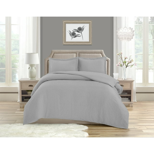 King size bed dressed in Swift Home Dot Clip light gray textured duvet cover set with small dots and zipper closure, paired with matching pillow shams and beige upholstered headboard in a sunlit modern bedroom.