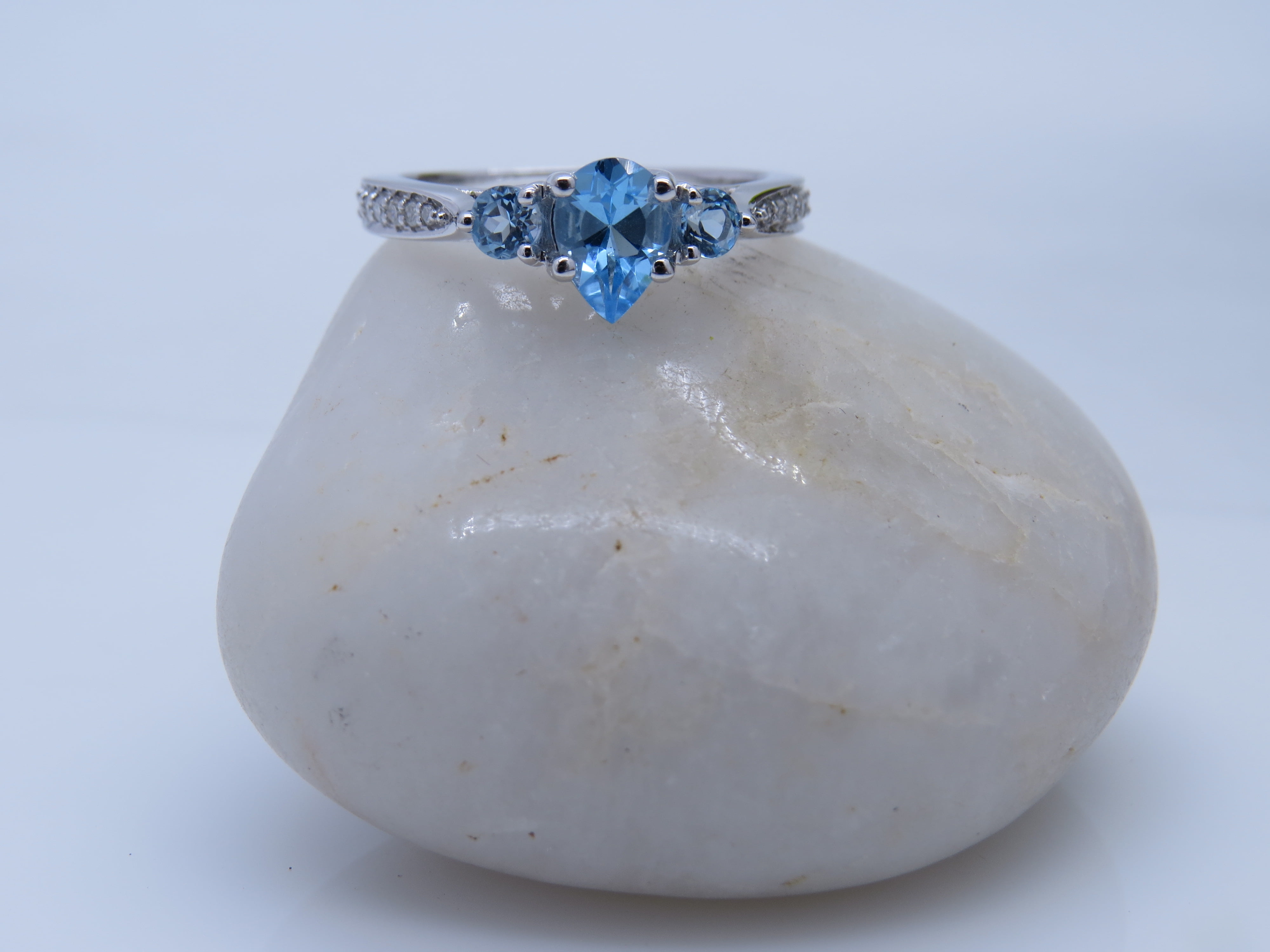 Dazzlingrock Collection 7X5MM Pear Blue Topaz & Round White Diamond 3 Stone Teardrop Engagement Ring for Women (0.10 ctw, Color I-J, Clarity I1-I2) in 18K White Gold, Size 7.5