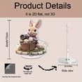 thumbnail image 2 of Rotating acrylic display showcasing a realistic bunny in a flowery Easter basket holding a camera on a cobblestone platform with intricate details, 2 of 8