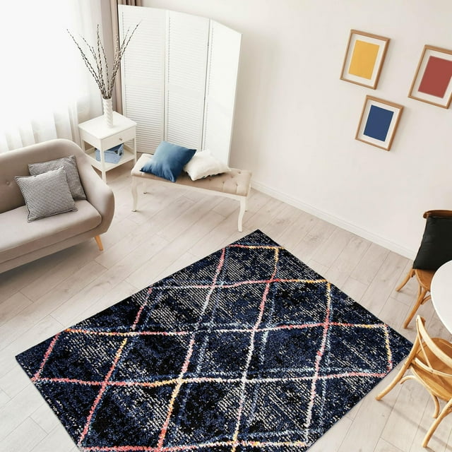 Ultra soft dark blue trellis area rug with colorful intersecting lines placed on light wood floor in a bright living room.