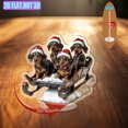 thumbnail image 1 of Rotating acrylic display features three dachshunds in Santa hats on a sled with vivid colors and intricate details against a white background, 1 of 6