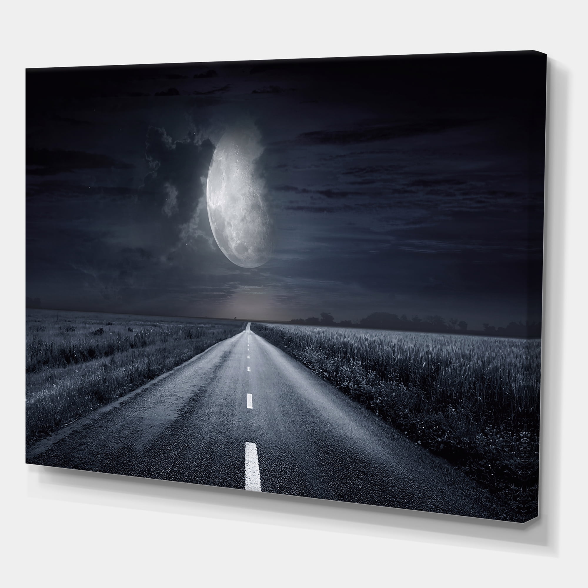 Cloudy Full Moon Over Asphalt Road III 32 in x 24 in Photography Canvas Art Print, by Designart