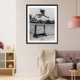 thumbnail image 3 of Historic Framed Print, Perfect form. Marion Mary Fitting, of the Pasedena Athletic Club, clears a hurdle during training for international women's meet at Prague, 17-7/8" x 21-7/8", 3 of 9