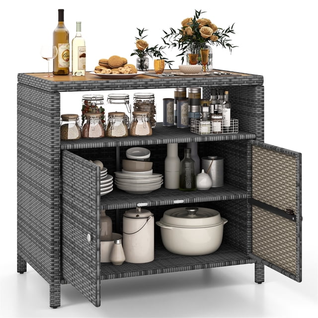 Gymax Patio Rattan Storage Cabinet with Acacia Wood Countertop, mixed grey PE rattan design, open shelf, and two-door cabinet. Ideal for patio storage, it features a spacious top for food and decor, enclosed shelves for garden tools, and adjustable foot pads for stability. Suitable for organizing poolside items.