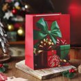 thumbnail image 1 of Bolsa de compras de papel navideña roja | Embalaje para regalo festivo con asa | Bolsa reutilizable con estampado de copos de nieve de Papá Noel, 1 of 5