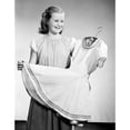 thumbnail image 2 of Studio shot of smiling girl holding new dress on hanger Poster Print (18 x 24), 2 of 4