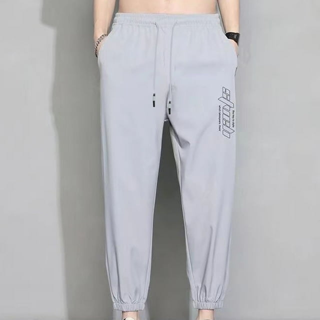 Pantalones casuales de moda para hombre, con bolsillos y tobillos, color liso, cintura elástica y cordón ajustable.