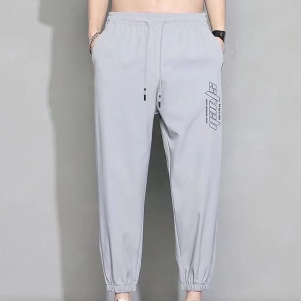 Pantalones casuales de moda para hombre, con bolsillos y tobillos, color liso, cintura elástica y cordón ajustable.
