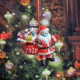 thumbnail image 2 of Estatua navideña pequeña de Papá Noel con mascarilla que lleva herramientas de limpieza, 2 of 5