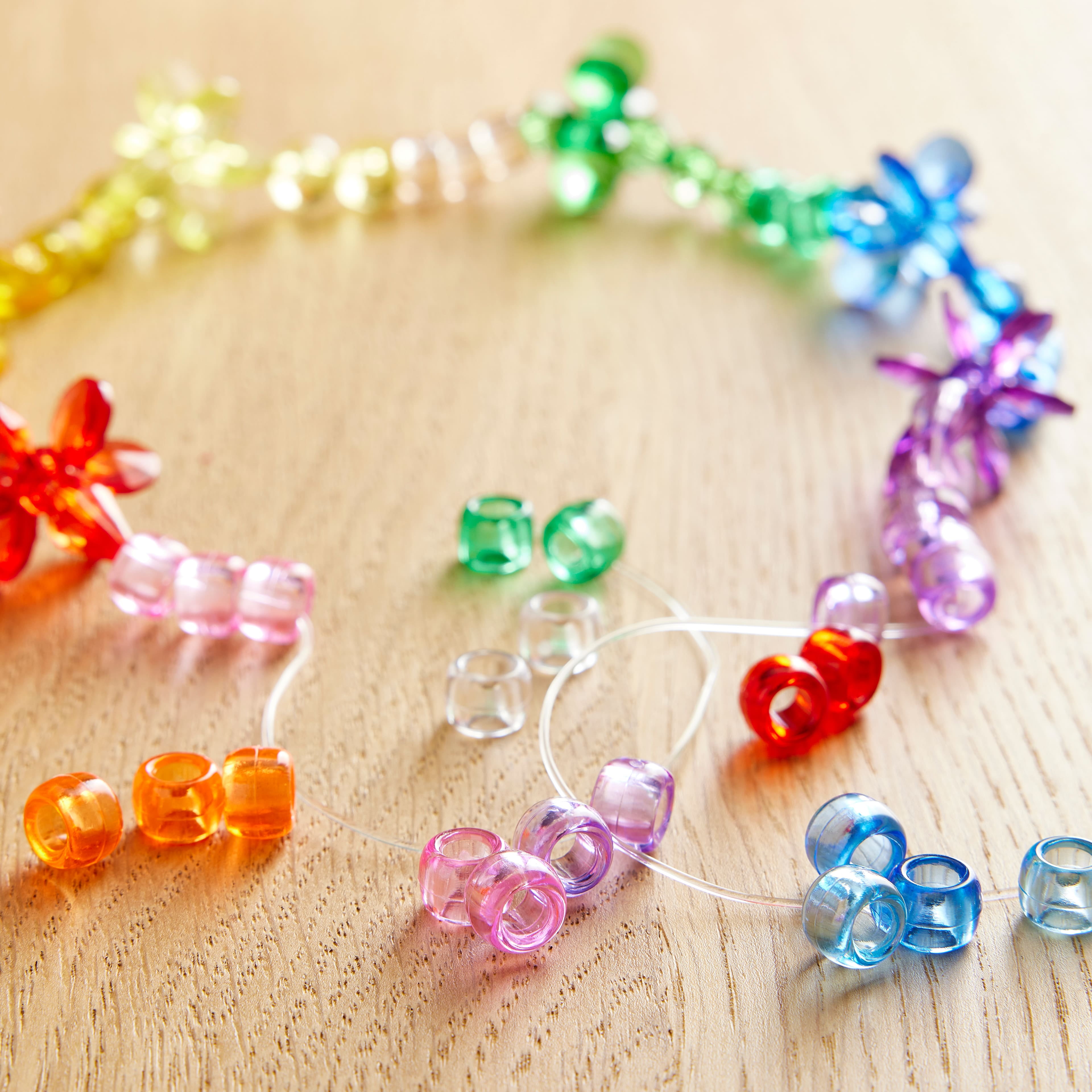 12 Packs: 580 ct. (6,960 total) Multicolor Transparent Pony Beads by Creatology - 6mm x 9mm
