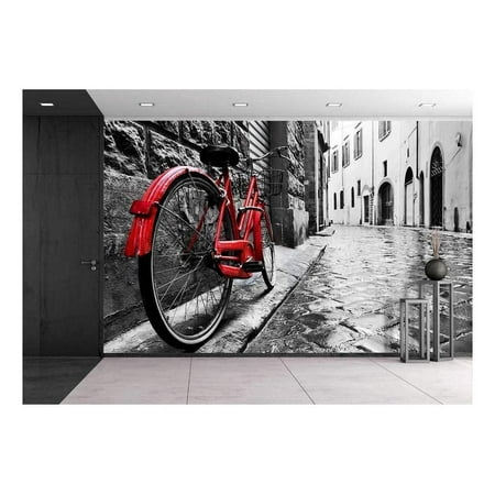 wall26 - Retro Vintage Red Bike on Cobblestone Street in The Old Town. Color in Black and White. Old Charming Bicycle Concept - Removable Wall Mural | Self-Adhesive Large Wallpaper - 66x96