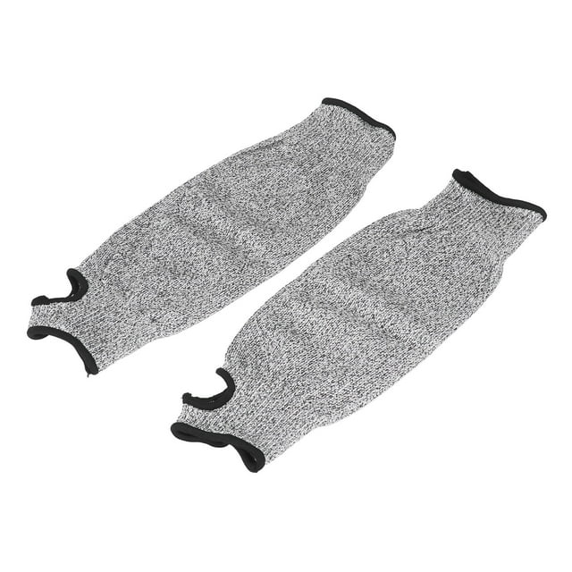 Arm Protection Sleeves, Cut Resistant Arm Sleeves Protective Mechanic Sleeves Safety Arm Guard in grey color. Made of HPPE material, these sleeves offer level 5 protection against cuts and scratches. They feature a thumb hole for a secure fit and are approximately 36 cm (14.17 inches) in length. Suitable for various applications such as gardening, glass handling, wood carving, and metalworking. Includes two cut-resistant arm sleeves.