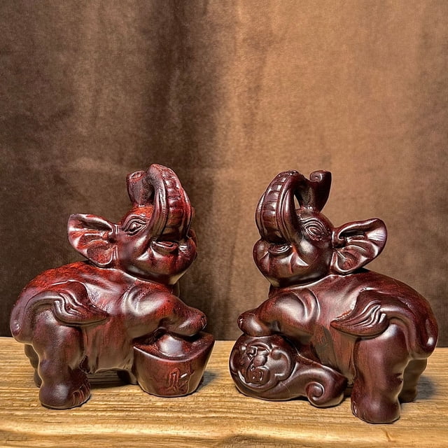A pair of ebony wood carved elephant figurines for home, office, decorative crafts, shop openings, or as gifts for new homes.