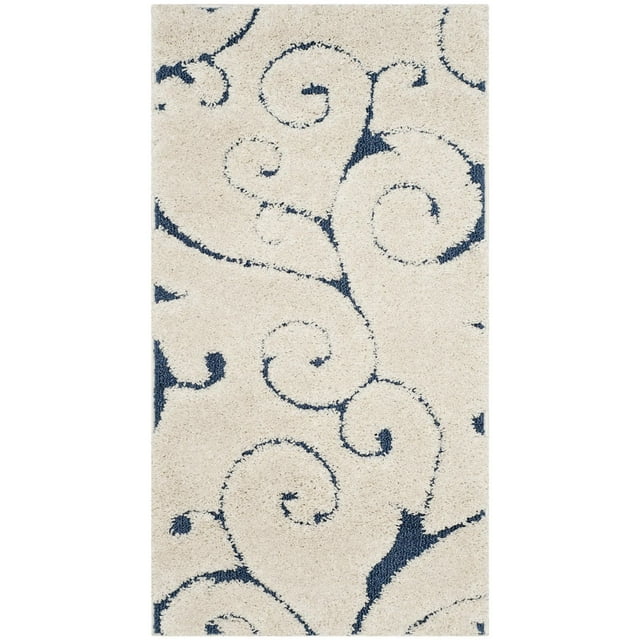 shag area rug with cream background featuring navy blue floral vine swirl patterns