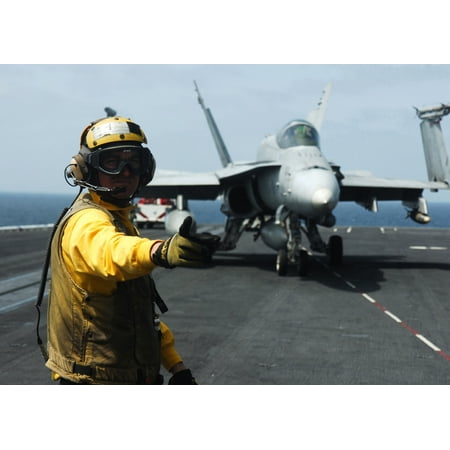 Directors Showcase Cotton - Canvas Print A U.S. Navy plane director directs the pilot of an F/A-18 Hornet to the next director aboard the Nim Stretched Canvas 10 x 14