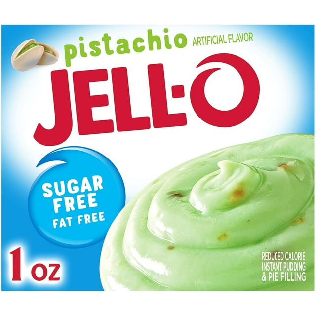 jell-o pistachio sugar free & fat free instant pudding & pie filling mix (24 ct pack, 1 oz boxes) Caja frontal con una porción girada de pudding pistache verde claro con pequeños trozos, logo rojo JELL-O, sello azul 'SUGAR FREE FAT FREE' y marca '1 oz' sobre fondo blanco-azul; ideal para preparar postres como pay, pastel poke o galletas de pistache.